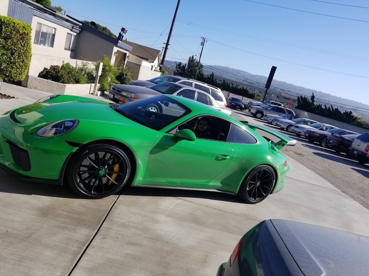 A lime green Porsche 911 GT3 RS parked on the forecourt at Nery's Auto Repair